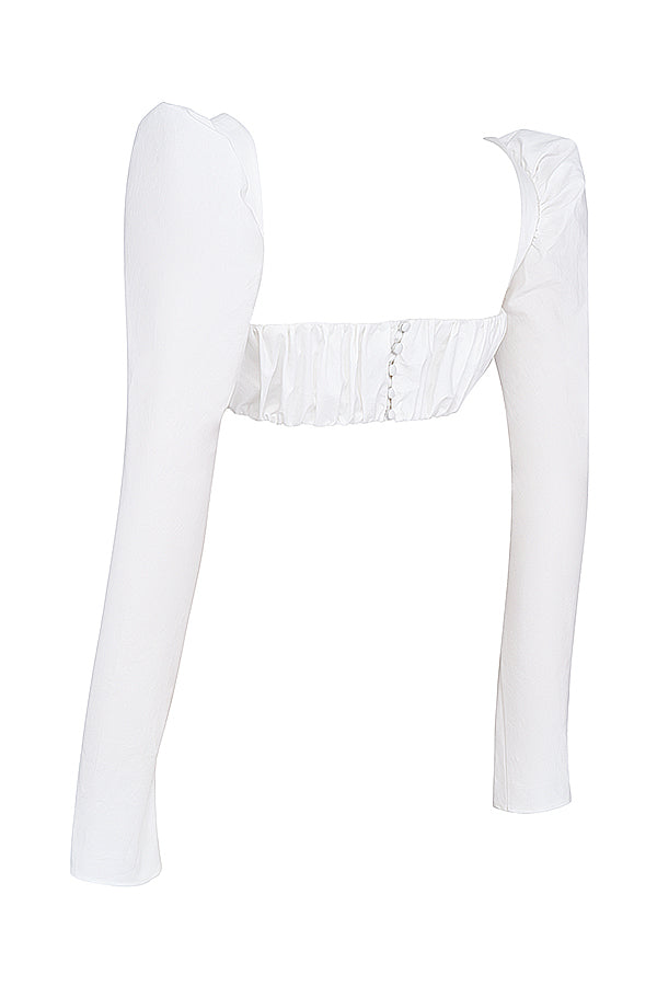Top blanc à manches bouffantes et mini jupe avec nàud