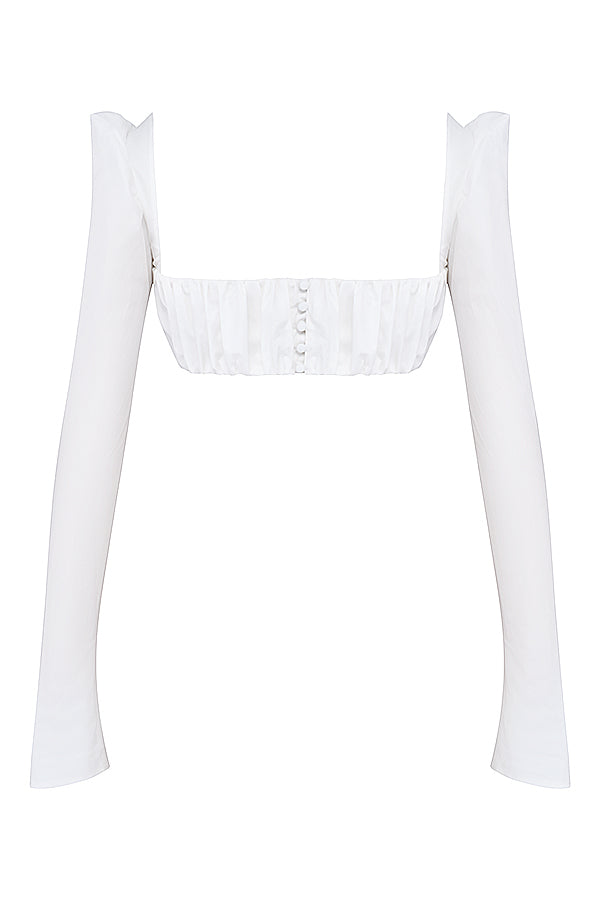 Top blanc à manches bouffantes et mini jupe avec nàud